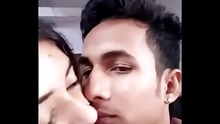 Girlfriend boyfriend kissing upon a room